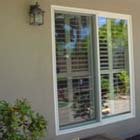 We replaced this single pane drafty aluminum patio door with an energy effecient double pane white vinyl patio door.